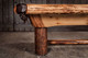 Close corner-side image of the Doc & Holliday Logan Logger slate pool table showing the massive lodgepole pine leg with dark burl highlights and natural knots. The frame captures the hand-stitched leather drop pocket, rounded log rail, and rugged joinery—Made in USA craftsmanship built around a true 3-piece 1" slate playfield. Rustic, country-style design with real timber presence. Close corner-side image of the Doc & Holliday Logan Logger slate pool table showing the massive lodgepole pine leg with dark burl highlights and natural knots. The frame captures the hand-stitched leather drop pocket, rounded log rail, and rugged joinery—Made in USA craftsmanship built around a true 3-piece 1" slate playfield. Rustic, country-style design with real timber presence.